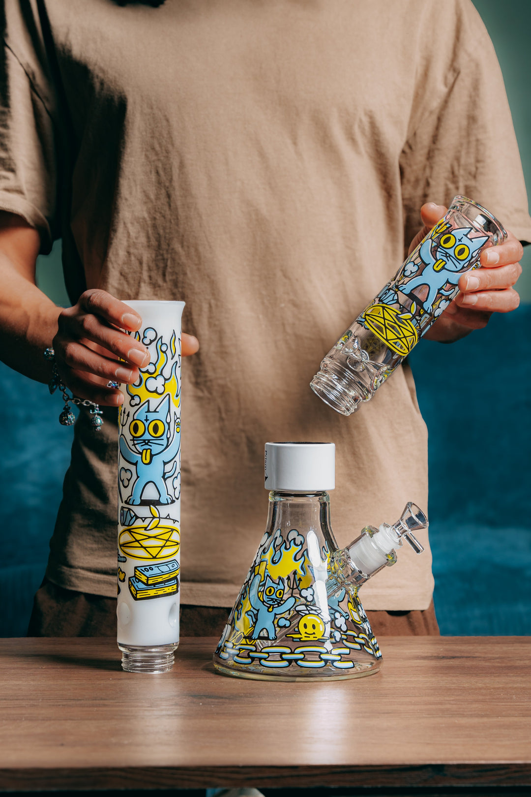 Person holding the modular pieces of the Prism 666 Cat Beaker Double Stack glass bong