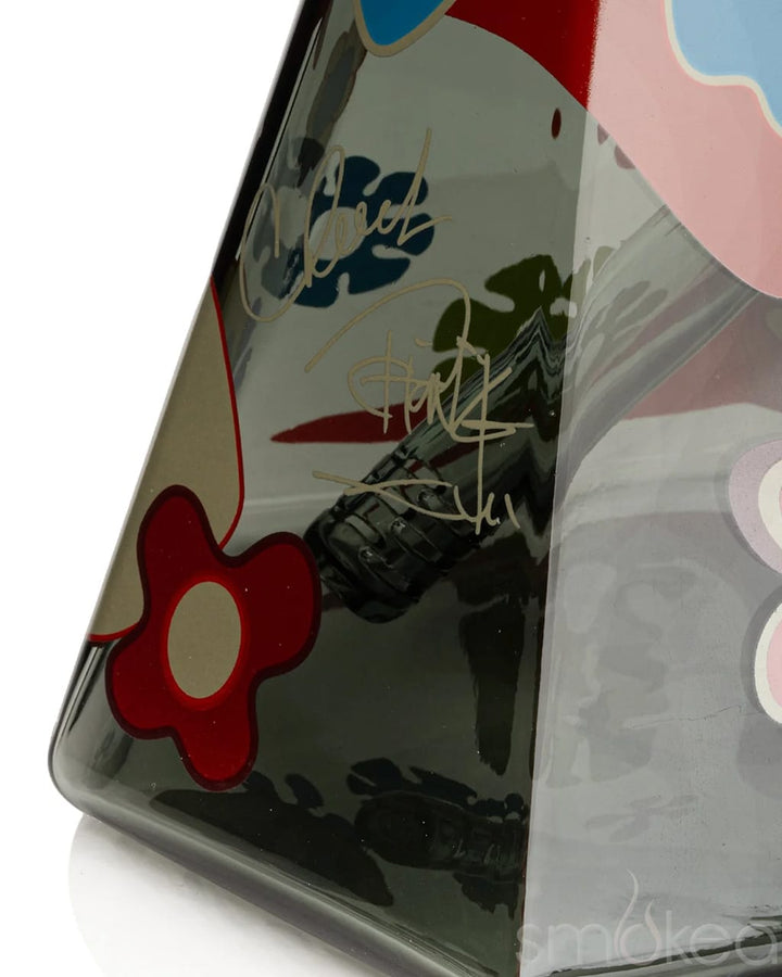 Close-up of hex beaker base showing Cheech & Chong signature decal and red floral graphic