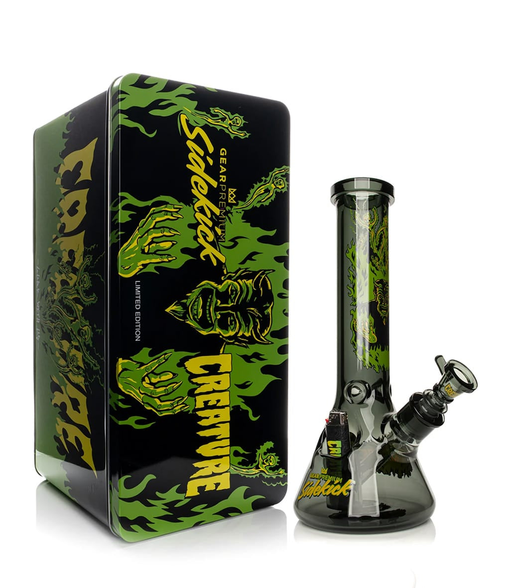 GEAR Premium x Creature Hell Sidekick bong displayed next to its collectible tin packaging