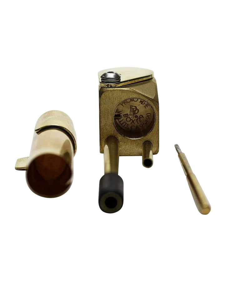 Proto Pipe Classic brass hand pipe fully disassembled showing bowl lid, engraved body, and poker tool